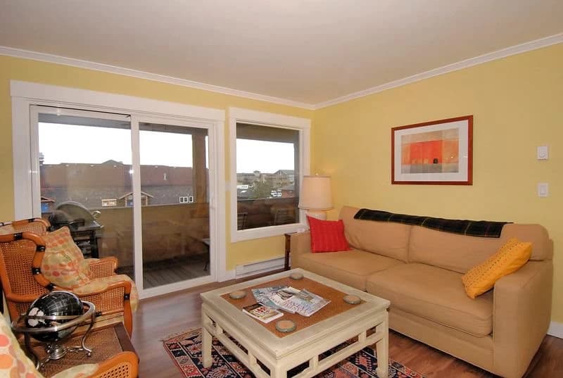 Bright yellow living room with balcony views