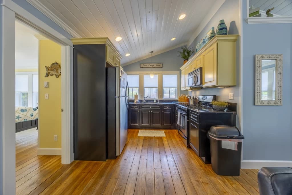 Galley kitchen with yellow cabinetry