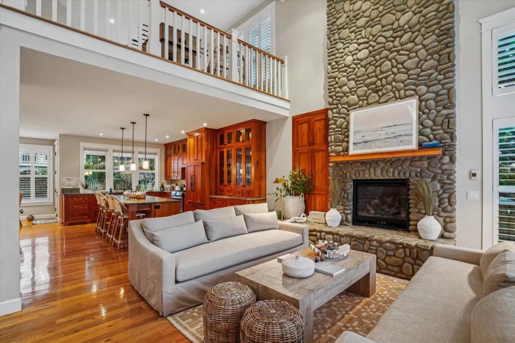 Two-story living room with stone fireplace