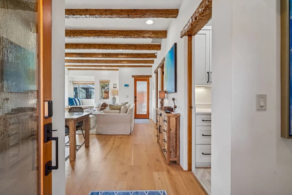 Open-concept living space with exposed beams